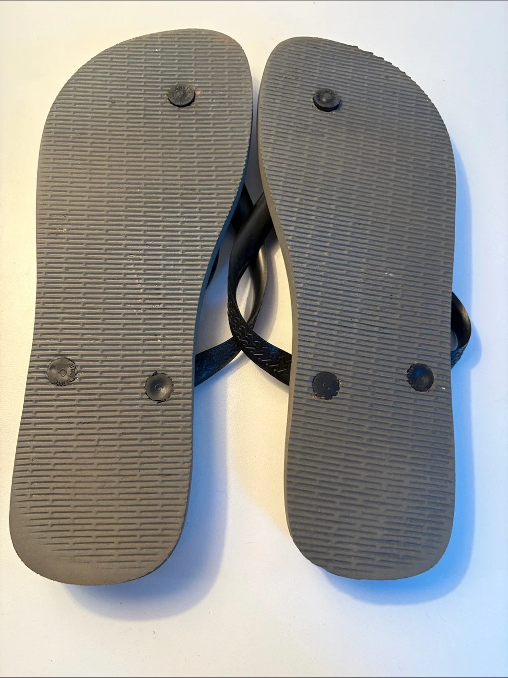 THREE pairs of men’s flip flops